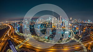 Panoramic skyline of Dubai with business bay and downtown district day to night timelapse.