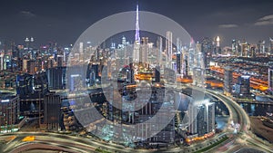 Panoramic skyline of Dubai with business bay and downtown district night timelapse.