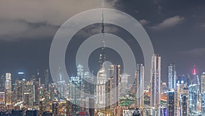 Panoramic skyline of Dubai with business bay and downtown district night timelapse.