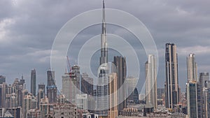 Panoramic skyline of Dubai with business bay and downtown district night to day .