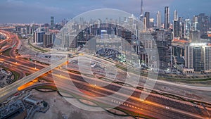 Panoramic skyline of Dubai with business bay and downtown district night to day timelapse.