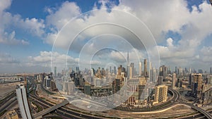 Panoramic skyline of Dubai with business bay and downtown district night to day timelapse.