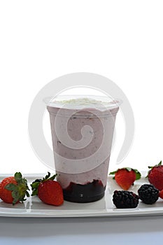 Panoramic still life of colorful frozen fruit granita drinks flowing in plastic takeaway cups with ice cream straws