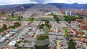 Panoramic of the streets, parks and buildings of the city of Bogota colorful sunset between the trees and green meadows