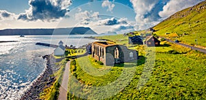 Panoramic summer view from flying drone of Kirkjubour village with Hestur Island on background.