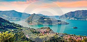 Panoramic summer view of Iseo lake. Impressive sunrise on Marone town with Monte Isola island, Province of Brescia, Italy, Europe. photo