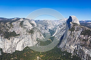 Panoramic summer view of Yosemite valley with Half Dome mountain, Tenaya Canyon, Liberty Cap, Vernal Fall and Nevada Fall, seen