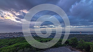 Panoramic sunrise view over Lisbon and Almada from a viewpoint in Monsanto morning timelapse. photo