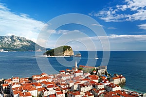 Panoramic sunset aerial drone view of the ancient city of Budva, Montenegro and St Nicholas island. Old medieval town