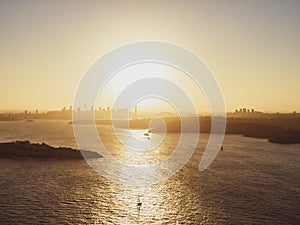 Panoramic sunset aerial drone view of famous Sydney Harbour with the CBD city centre skyline in the background. South Head