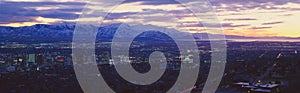 Panoramic sunset of Salt Lake City with snow capped Wasatch Mountains