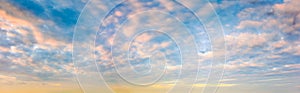 Panoramic sunset sky. Overcast clouds in pastel colors. Only the sky