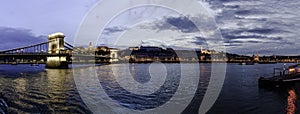 Panoramic sunset view of the Buda shore with Buda Castle, Chain Bridge and Fishermen`s Bastion, Budapest, Hungary