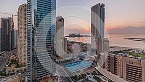 Panoramic sunset view of the Dubai Marina and JBR area and the famous Ferris Wheel aerial timelapse