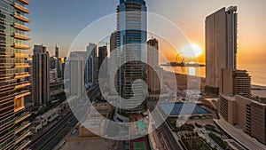 Panoramic sunset view of the Dubai Marina and JBR area and the famous Ferris Wheel aerial timelapse