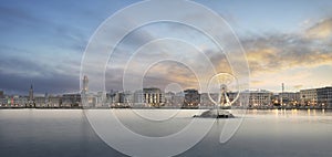 Panoramic sunset view of Illuminated giant Ferris wheel in Bari, Italy