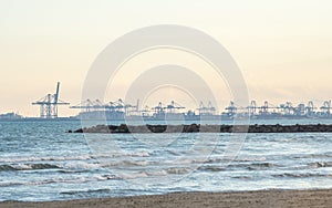 panoramic sunset view port in the Valencia harbor cranes transport From the beach