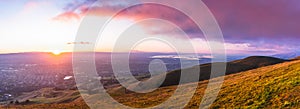 Panoramic sunset view of San Jose and South San Francisco Bay Area, also known as Silicon Valley; hills starting to turn green