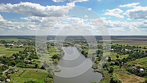 Panoramic video from drone above countryside in a summer cloudy day.