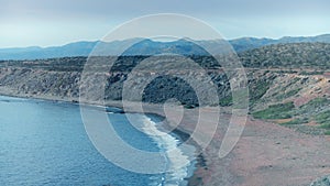 Panoramic view from above rocky cliff from sea water on empty coast line