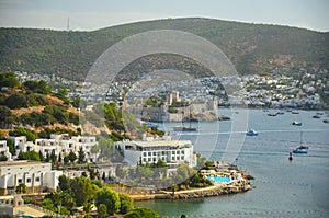 Panoramic View of Aegean sea, traditional white houses marina and Bodrum Castle in Bodrum city of Turkey.