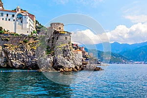 Panoramic view, aerial skyline of small haven of Amalfi village with tiny beach and colorful houses located on rock. Tops of