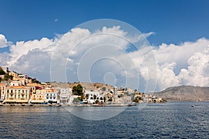 Panoramic view, aerial skyline of small haven of Symi island. Village with tiny beach and colorful houses located on