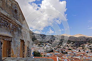 Panoramic view, aerial skyline of small haven of Symi island. Village with tiny beach and colorful houses located on