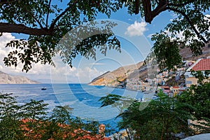 Panoramic view, aerial skyline of small haven of Symi island. Village with tiny beach and colorful houses located on