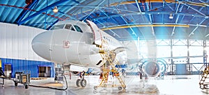 Panoramic view of aerospace hangar, civil aviation aircraft, repair and maintenance of mechanical parts in an industrial workshop