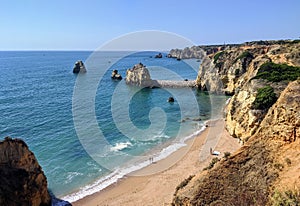 Panoramic view of Algarve\'s turquoise sea, sandy beaches and cliffs under a blue sky
