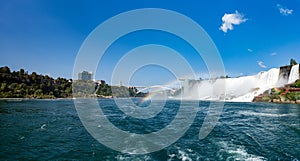Panoramic view of American Falls, Niagara Falls Observation Tower and Rainbow Bridge from the Niagara River