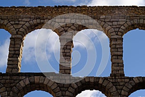 Panoramic view ancient Roman aqueduct on Plaza del Azoguejo with the sky on the background photo