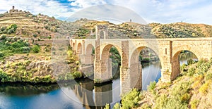 Panoramic view at the ancient Roman bridge over Tajo river in Alcantara, Spain