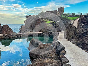 Porto Moniz - Panoramic view of the aquarium in coastal town Porto Moniz, Madeira island, Portugal, Europe. Stone castle photo