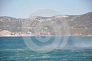 Panoramic view of Bakar city with rough Adriatic sea in Croatia.Rough Adriatic Sea and Bura wind in Bakar gulf. photo