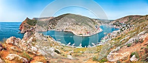 Panoramic view of Balaklava bay with yachts and ruines of Genoese fortress Chembalo in Sevastopol city from the height