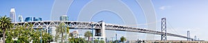 Panoramic view of the Bay Bridge spanning from the Financial District to Treasure Island on a sunny and clear day, San Francisco,