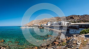 Panoramic view on bay with small beach in centre of Chora Sfakion town, Crete, Greece
