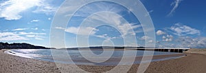 Panoramic view of the beach at arnside with the leven railway viaduct and river in the south lakes area of cumbria