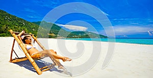Panoramic view of the beach with an attractive woman sunbathing