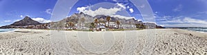 Panoramic view from the beach over the village of Camps Bay near Cape Town to the towering Table Mountains in the background