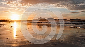 Panoramic view of beautiful golden hour on the Famara. Beach in Lanzarote - Canary Islands. Photo of sunset on the beach with