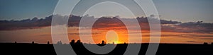 Panoramic view of a beautiful summer sunset and clouds.