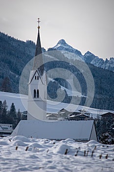 Panoramic view of beautiful winter wonderland mountain scenery in the Alps with pilgrimage church of Maria Gern and