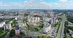 Panoramic view of a big city with skyscrapers and white fluffy clouds floating across the blue sky