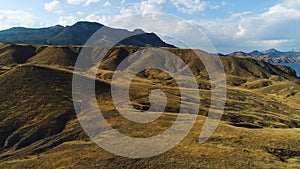 Panoramic view of Black Sea coastline mountains and yellow hills on a sunny autumn day, hiking and nature concept. Shot