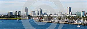 The panoramic view of the boat harbor and buildings in the city along Queensway Bay on a sunny day near Long Beach, California