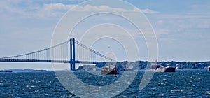 Panoramic view of boats sailing in the sea against Verrazano Bridge in New York city on a sunny day