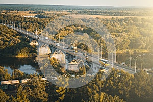 Panoramic view of bridge over river Klyazma in Vladimir city with railroad and green trees in summer day, toned photo